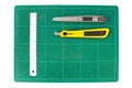 Green cutting mats with iron ruler and cuter on white background Royalty Free Stock Photo