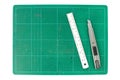 Green cutting mats with iron ruler and cuter on white background Royalty Free Stock Photo