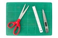 Green cutting mats with scissors ruler and cuter on white background Royalty Free Stock Photo