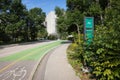 Green cyclist road with a cycling counter on the sidewalk on a bright sunny day in Winnipeg, Canada