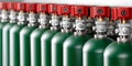Green cylinders with red valves form a line, containing gas for an automatic fire suppression system, ensuring building safety Royalty Free Stock Photo