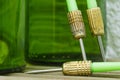 Green darts from a dartboard resting on beer bottles Royalty Free Stock Photo