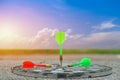 Green Darts and red arrow on the target center dartboard Royalty Free Stock Photo