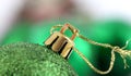 Green decorative christmas ball detail. gold colored hanging rope.macro shot in studio,