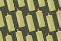 Green decorative interior flat candle with flame. Vector cartoon seamless pattern