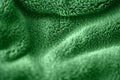 Green delicate soft background of fur plush smooth fabric. Texture of purple soft fleecy blanket textile Royalty Free Stock Photo