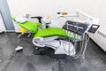 Green dental chair and medical equipment at the dental clinic. The concept of healthcare and treatment in medical