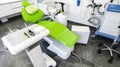 Green dental chair and medical equipment at the dental clinic. The concept of healthcare and treatment in medical