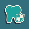 Green Dental protection icon isolated on green background. Tooth on shield logo. Long shadow style. Vector