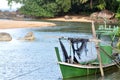 A green derelict fishing boat moored in a small stream Royalty Free Stock Photo