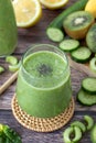 Green detox smoothie with cucumber, celery, kiwi, spinach, banana, and avocado for breakfast