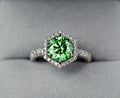 A green diamond ring with a white band Royalty Free Stock Photo