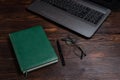 Green diary on the table. Diary and laptop. Notepad, laptop and glasses. Keep a diary entry Royalty Free Stock Photo