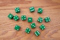 Green Dice scattered on an Oak Table Royalty Free Stock Photo
