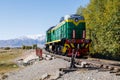 green diesel locomotive crossing small bridge at summer day in Balykchy, Kyrgyzstan Royalty Free Stock Photo