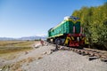 green diesel locomotive crossing small bridge at summer day in Balykchy, Kyrgyzstan Royalty Free Stock Photo