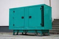 Green diesel powered generator connected to building Royalty Free Stock Photo