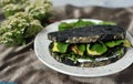 Green diet conceptual image with black charcoal bread and veggie sandwich