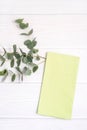 Green dish towel and twig of Eucalyptus on white wood table Royalty Free Stock Photo