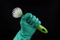 Green dishwashing brush with rubber glove isolated on black, lets work in household concept Royalty Free Stock Photo
