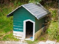 Green Dog House with Aluminum Roof Royalty Free Stock Photo