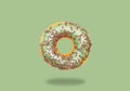 Green donut on on pastel green background