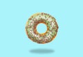 Green donut on on pastel blue background