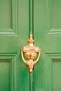 Green door with brass knocker Royalty Free Stock Photo