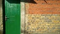 Green door and brick wall Royalty Free Stock Photo