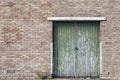 Green door build into a old brick wall