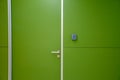 Green door with coded door lock or code keypad on a green wall background and soft light for concept of Interior design Royalty Free Stock Photo