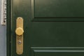 Green door with golden knob Royalty Free Stock Photo