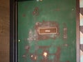 Green door office door card with paint stripping and rundown