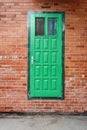 Green door on a red brick wall Royalty Free Stock Photo