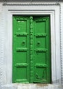 Green door in white wall, white and green house decoration