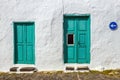 Green door and window on white wall Royalty Free Stock Photo