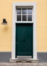 A green door on a yellow building in a German village Royalty Free Stock Photo