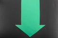 Green down direction blank paper arrow with space for text on black background Royalty Free Stock Photo