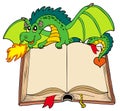 Green dragon holding old book Royalty Free Stock Photo