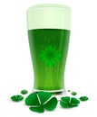 Green drink ale in high transparent glass. Green leaf quatrefoil clover symbol of St. Patricks Day