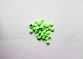 Green drug pills in pile on white background Royalty Free Stock Photo