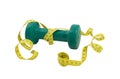 Green dumbbell and yellow tape measure on a white