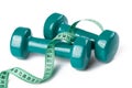 Green dumbell with measuring tape Royalty Free Stock Photo