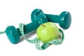 Green dumbell with measuring tape Royalty Free Stock Photo