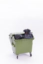 A green dust bin full Royalty Free Stock Photo