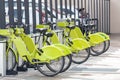 Green e-bikes are located in the shared parking