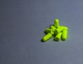 Green earplugs on a gray background-image