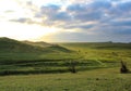 The green earth, green grass and the blue sky, nature landscape with hills green and the sun