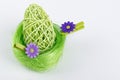 Green Easter Egg in green nest with grey background Royalty Free Stock Photo