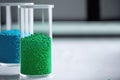 Green eco-friendly plastic granules in test tubes
